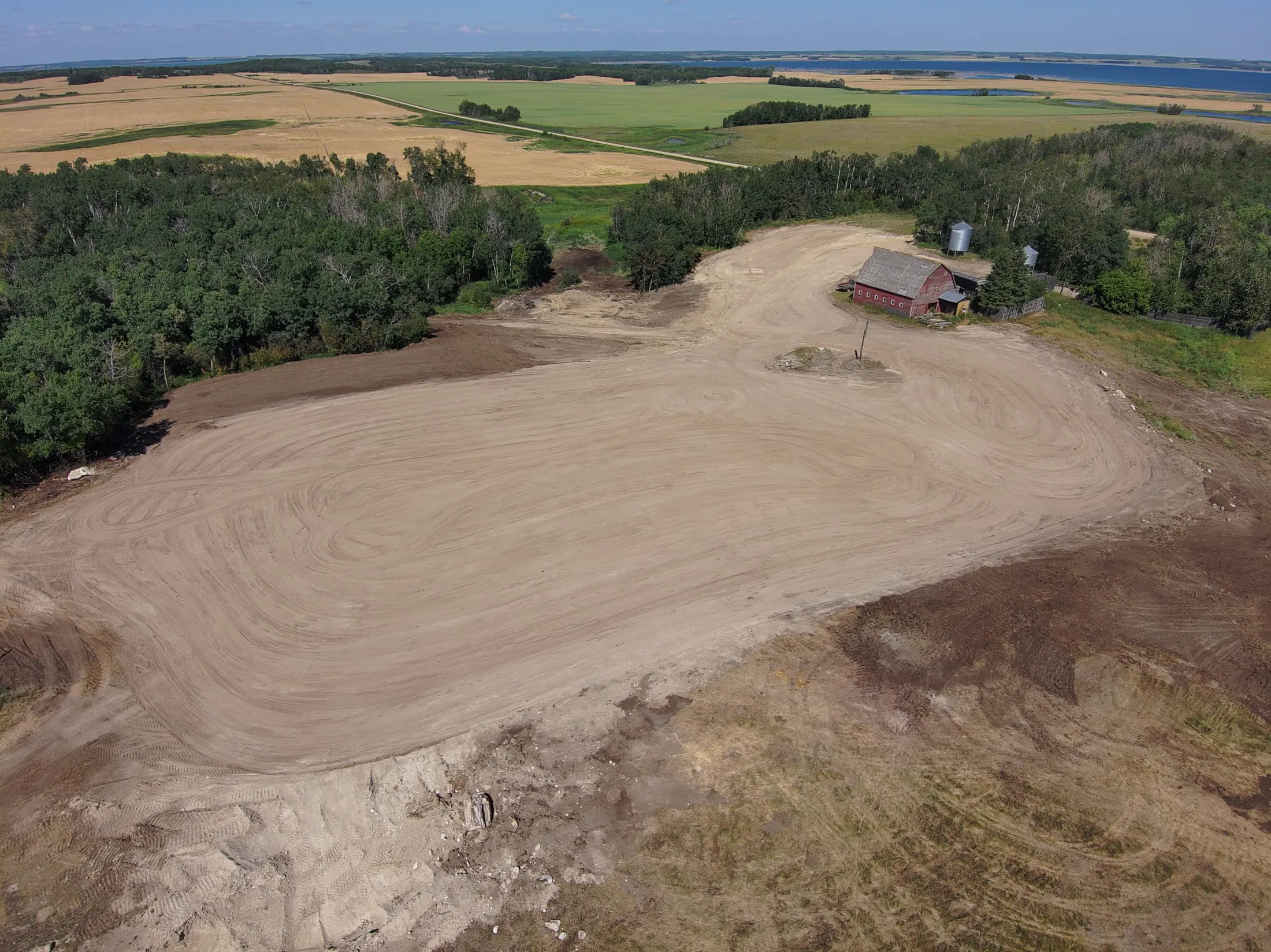 Aerial view of a freshly graded prairie building pad shaped by Hard Work Industries near Middle Lake, Saskatchewan