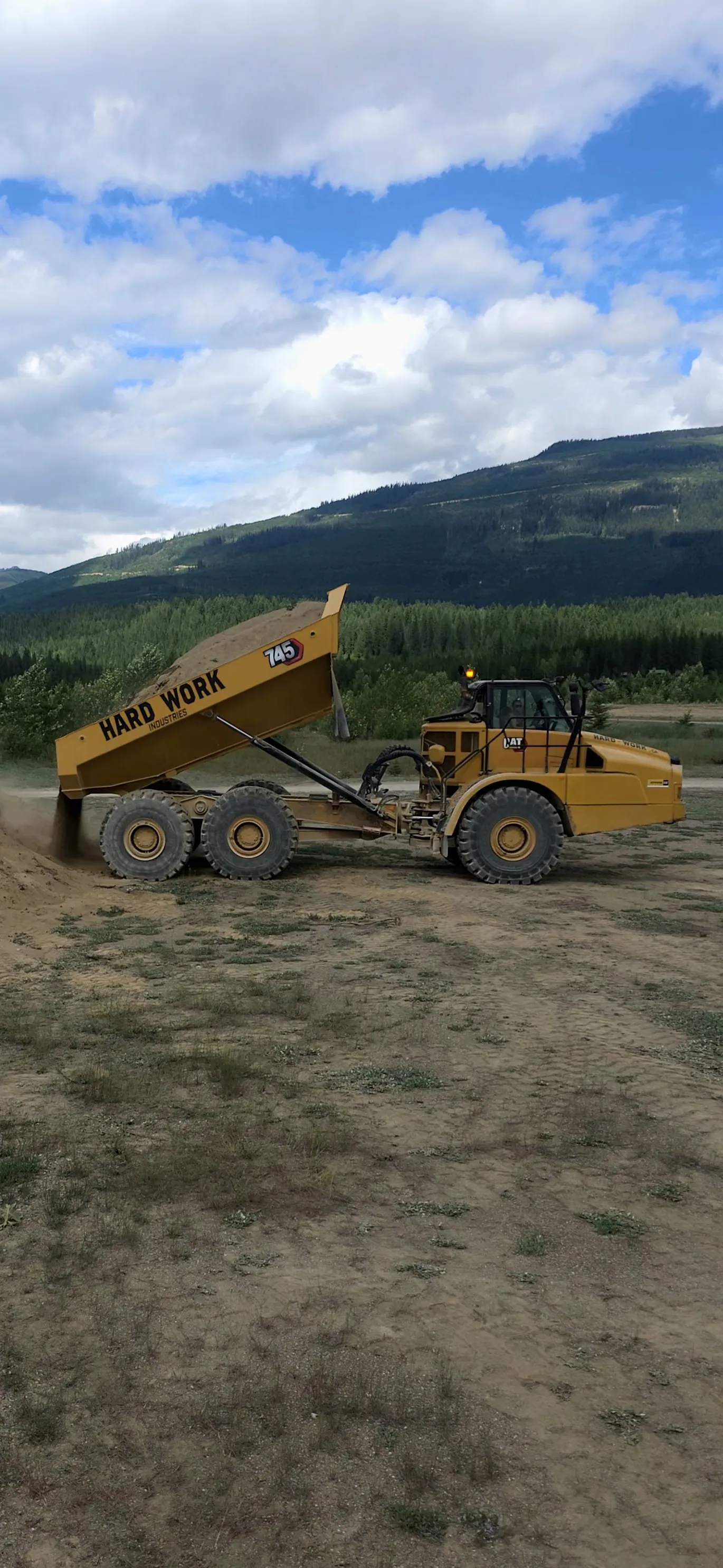 Off-road 45-tonne articulated haul truck moving material on a Hard Work Industries earthworks site