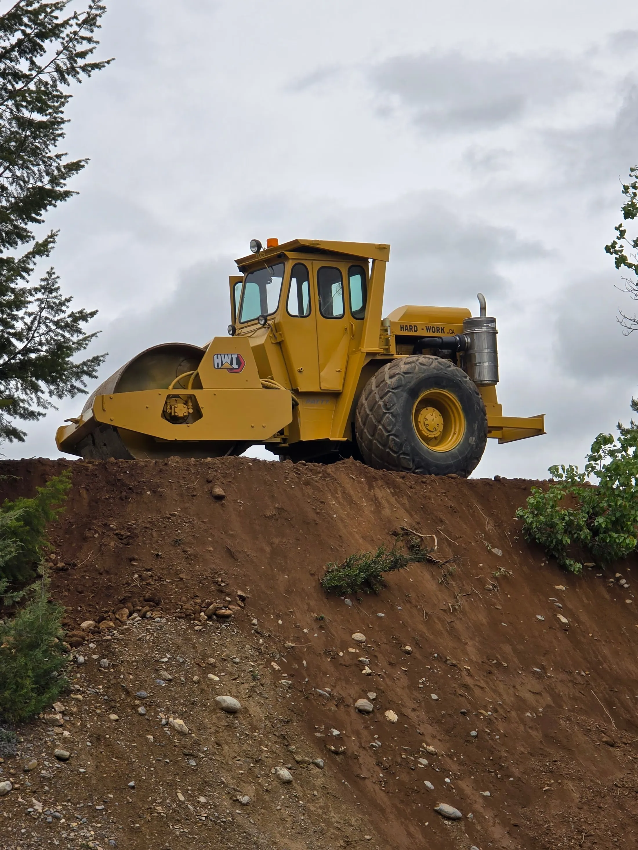 Vibratory packer compacting a base